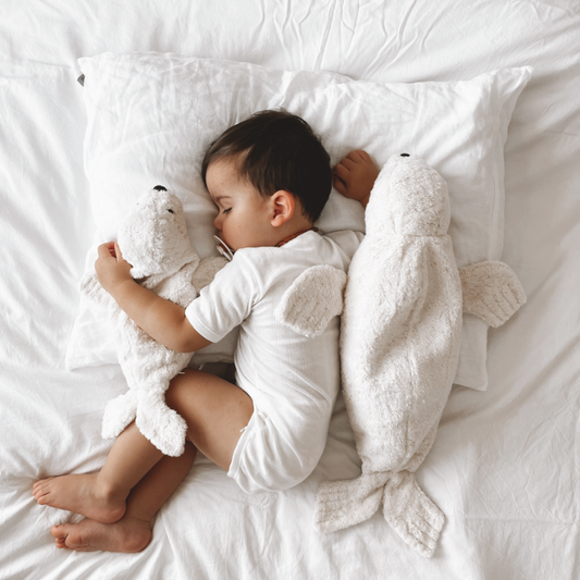 Senger warmte knuffel zeehond groot wit in bed met een kindje