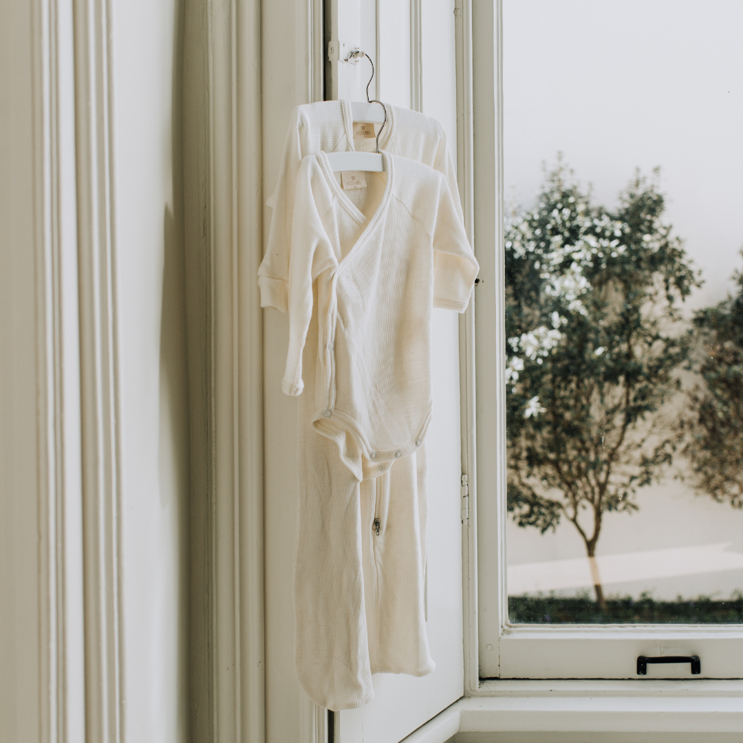 wollen overslagromper baby newborn wit kico label